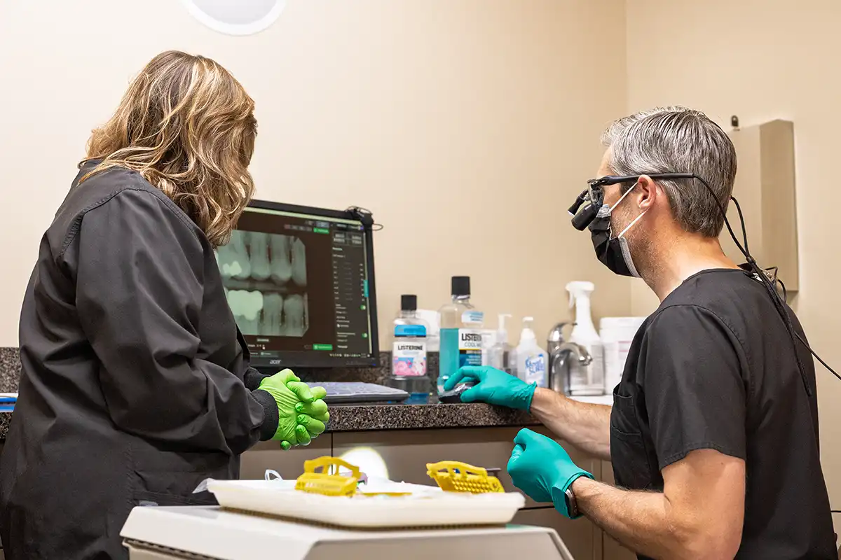 Dr. Pranckun looking at an x-ray with assistant.